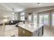 Open floor plan, showcasing kitchen island open to the living room with large windows at 6021 Winter Meadow St, Las Vegas, NV 89130
