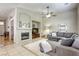 Open living area showcasing a fireplace, a grey sectional sofa, and an inviting atmosphere at 6021 Winter Meadow St, Las Vegas, NV 89130