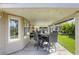 Covered patio area offers outdoor dining space and views of the backyard at 6021 Winter Meadow St, Las Vegas, NV 89130