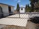 View of fenced-in backyard with concrete patio space, and shed with window at 626 Kimberly Ave, Pahrump, NV 89060