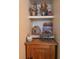 Interior decor on a wooden cabinet featuring a toy wagon and dried flowers at 626 Kimberly Ave, Pahrump, NV 89060