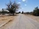 A gravel driveway leads up to the home and property at 626 Kimberly Ave, Pahrump, NV 89060