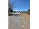 Long gravel driveway leading to the property with chain-link fence borders at 626 Kimberly Ave, Pahrump, NV 89060