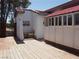Exterior view of a red roof, white-sided building and wood deck at 626 Kimberly Ave, Pahrump, NV 89060