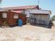 Exterior view of a home with a red roof and attached sheds and kennels at 626 Kimberly Ave, Pahrump, NV 89060