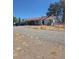 Single-story home with a red tile roof, covered porch, and ample parking at 626 Kimberly Ave, Pahrump, NV 89060