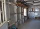 Large garage interior, featuring metal siding and wooden shelves on the wall, with a window at 626 Kimberly Ave, Pahrump, NV 89060