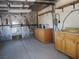 Inside view of a large garage with metal siding and built-in wooden cabinets and shelves at 626 Kimberly Ave, Pahrump, NV 89060