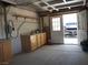Garage with storage and cabinets, featuring an open door revealing a vehicle outside at 626 Kimberly Ave, Pahrump, NV 89060