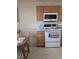 Traditional kitchen with wooden cabinets and tiled floor at 626 Kimberly Ave, Pahrump, NV 89060