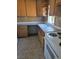 Practical kitchen with white countertops and range, wooden cabinets and tile flooring at 626 Kimberly Ave, Pahrump, NV 89060