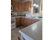 Kitchen with wood cabinets, white counter top, and tiled floors at 626 Kimberly Ave, Pahrump, NV 89060