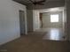 Spacious living room featuring carpet and tile flooring, a ceiling fan, and bright natural light at 626 Kimberly Ave, Pahrump, NV 89060