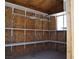 Inside the outbuilding, featuring plywood walls, shelving, and a window for natural light at 626 Kimberly Ave, Pahrump, NV 89060