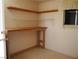 Interior view of room featuring a built in wooden workbench and shelving at 626 Kimberly Ave, Pahrump, NV 89060