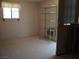 View of a room featuring a window, shelving, and a metal storage rack at 626 Kimberly Ave, Pahrump, NV 89060