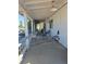 Covered porch features cool toned chairs, overhead lighting and white painted wooden ceiling at 626 Kimberly Ave, Pahrump, NV 89060