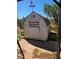Charming shed in the backyard with weather vane, adding character and practical storage at 626 Kimberly Ave, Pahrump, NV 89060