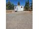 Exterior of shed featuring white and gray paint and gravel yard at 626 Kimberly Ave, Pahrump, NV 89060