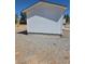 Exterior view of a white shed, offering additional storage or workshop space on the property at 626 Kimberly Ave, Pahrump, NV 89060