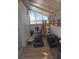 Enclosed sunroom with exercise bike, wood flooring, and bright natural light at 626 Kimberly Ave, Pahrump, NV 89060