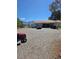 Spacious gravel driveway to home with red tile roof and mountain views at 626 Kimberly Ave, Pahrump, NV 89060