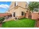 Private backyard with artificial grass, a brick patio, and space for outdoor dining at 6312 Snap Ridge St # 101, North Las Vegas, NV 89081