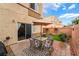 Enclosed backyard patio with an outdoor dining set under an umbrella at 6312 Snap Ridge St # 101, North Las Vegas, NV 89081