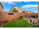Cozy backyard features artificial turf, brick patio with a table and chairs, and privacy fencing at 6312 Snap Ridge St # 101, North Las Vegas, NV 89081