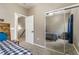 Bright bedroom with a checkered bedspread reflected in mirrored closet doors at 6312 Snap Ridge St # 101, North Las Vegas, NV 89081