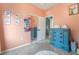 Charming peach-colored bedroom with blue dresser and ample closet space at 6312 Snap Ridge St # 101, North Las Vegas, NV 89081