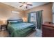 Comfortable bedroom with a ceiling fan, plush carpet, and large window at 6312 Snap Ridge St # 101, North Las Vegas, NV 89081