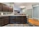 Open kitchen featuring dark wood cabinets and connecting dining area at 6312 Snap Ridge St # 101, North Las Vegas, NV 89081