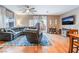 Cozy living room featuring hardwood floors, a comfortable sectional sofa, and a modern ceiling fan at 6312 Snap Ridge St # 101, North Las Vegas, NV 89081