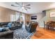 Spacious living room featuring wood floors, large sofa, recliner, and ceiling fan at 6312 Snap Ridge St # 101, North Las Vegas, NV 89081