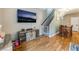 Open living room with hardwood floors and view of the stairway at 6312 Snap Ridge St # 101, North Las Vegas, NV 89081