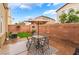 Cozy backyard patio area with a table and chairs for outdoor dining at 6312 Snap Ridge St # 101, North Las Vegas, NV 89081