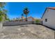 Large backyard with rock landscaping, cinder block wall and palm tree at 6432 Jean Lee Dr, Las Vegas, NV 89108