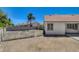 The backyard has rock landscaping, some fencing and mature palms at 6432 Jean Lee Dr, Las Vegas, NV 89108