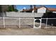 Fully fenced backyard area featuring a secure, gated dog run with gravel and concrete block at 6432 Jean Lee Dr, Las Vegas, NV 89108