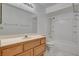 Bathroom with a light wood vanity, large mirror, and shower-tub combo at 6432 Jean Lee Dr, Las Vegas, NV 89108