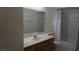 Bathroom featuring large mirror, white countertops, and a shower with white tiling at 6432 Jean Lee Dr, Las Vegas, NV 89108