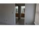 Bedroom with mirrored closet doors reflecting a bathroom space at 6432 Jean Lee Dr, Las Vegas, NV 89108