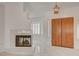 Inviting foyer with double doors, tile flooring, and a cozy fireplace at 6432 Jean Lee Dr, Las Vegas, NV 89108