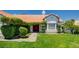 Charming single-story home with lush lawn and unique landscaping around front door at 6432 Jean Lee Dr, Las Vegas, NV 89108