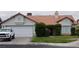 Charming single story home with a two car garage, red tile roof, and front yard with mature landscaping at 6432 Jean Lee Dr, Las Vegas, NV 89108