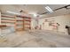 Spacious garage with ample storage featuring wooden shelving and lots of space for vehicles at 6432 Jean Lee Dr, Las Vegas, NV 89108