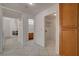 Hallway with neutral tile floor provides access to bathroom, laundry room, and front room at 6432 Jean Lee Dr, Las Vegas, NV 89108