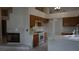 Open kitchen showcasing ample cabinetry, bright countertops, modern appliances, and a fireplace at 6432 Jean Lee Dr, Las Vegas, NV 89108