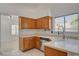 Bright kitchen boasts wooden cabinets, stainless steel appliances, and a window view at 6432 Jean Lee Dr, Las Vegas, NV 89108